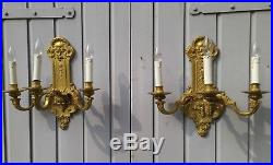 A pair of French Louis XV fire gilt bronze wall appliques, elec. Candle holders