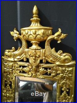 A pair of gilded bronze wall mirror candle holders, richly decorated, 19th cent
