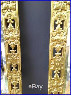 A pair of gilded bronze wall mirror candle holders, richly decorated, 19th cent