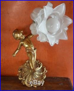 A vintage French bronze putti wall light with ornate petalled glass shade