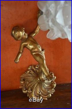 A vintage French bronze putti wall light with ornate petalled glass shade